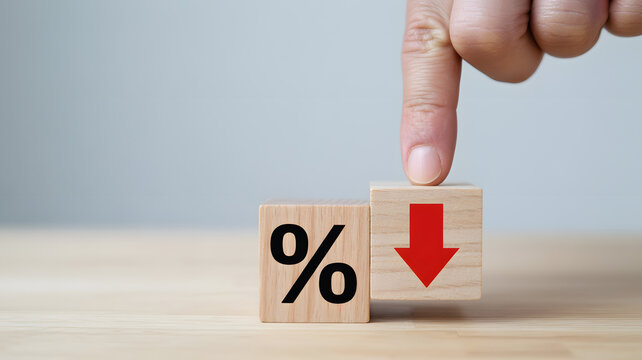 Finger pushes wooden block showing percentage down arrow