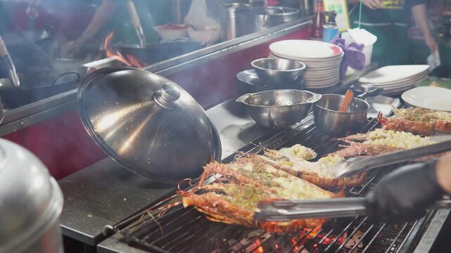  A street food vendor grills fresh spiny lobsters (langustas)