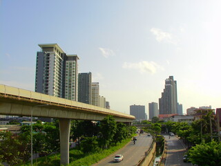 A raised railway track runs alongside city high-rise buildings, framed in retro tones with film grain for nostalgic effect.