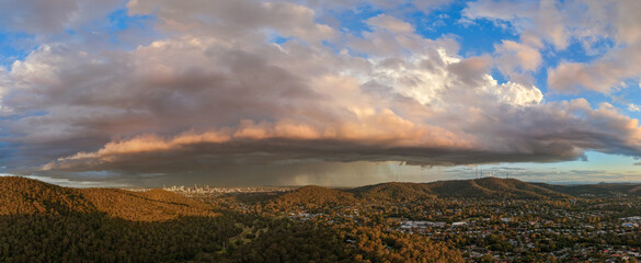 aerial view of storm clouds and rain over Brisbane city skyline 