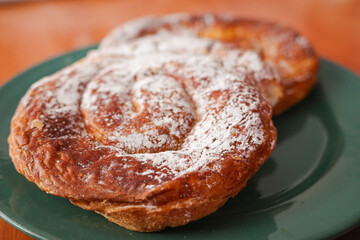 Traditional Mallorcan ensaimada pastry with powdered sugar on plate