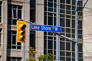 Naklejka premium Close up of Lake Shore Boulevard West street sign.