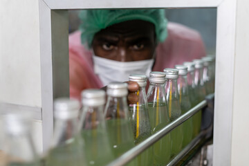 Factory of food or beverages, quality control check juice and water bottle, food or beverages on...