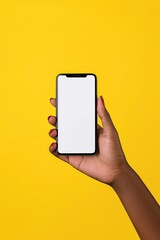 Hand of an African American woman holding a smartphone with blank screen on yellow background, showcasing modern technology and diverse lifestyle for communication concept