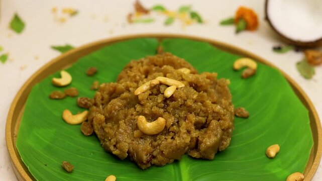 Moong dal halwa indian dessert with dry fruits on banana leaf