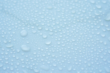 Beautiful water droplets on a smooth surface in soft light