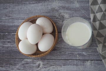 Breakfast ingredients with eggs and milk on the table