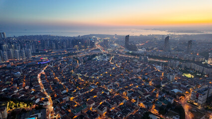 Istanbul city skyline at dusk with lights illuminating buildings in 