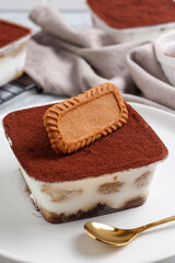 Tiramisu dessert box on a white plate.