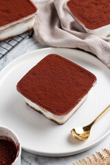 Tiramisu dessert box on a white plate.