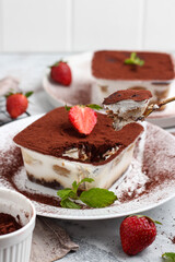 Tiramisu dessert box on a white plate.