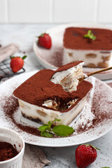 Tiramisu dessert box on a white plate.