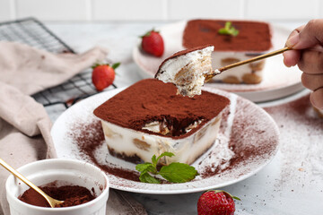 Tiramisu dessert box on a white plate.
