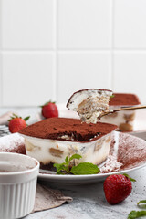 Tiramisu dessert box on a white plate.