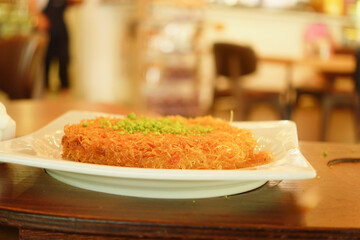 Delicious kunafa served on a white plate 
