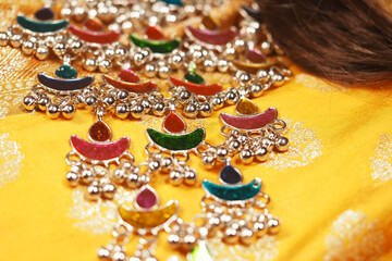 Colorful jewelry displayed on a vibrant yellow fabric