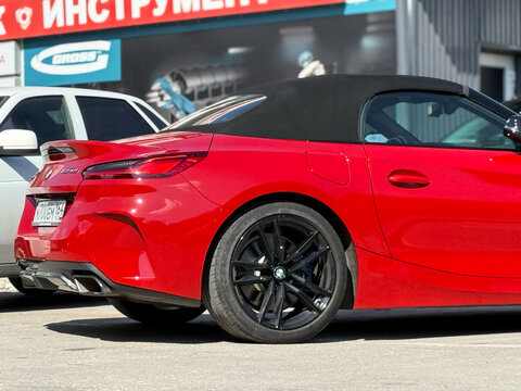 BMW Z4 M40i III (G29) red color parked on street. Exterior of red BMW Z4 M40i III (G29) sport coupe manufactured by the German automobile manufacturer on parking lot.