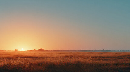 wide open field with warm orange glow at sunset, smooth clear sky transitioning from orange to pale blue, minimalist summer dusk scene with ample negative space