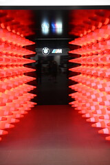 Installation of a wall made of illuminated red and white traffic cones