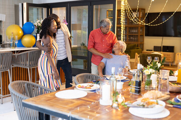 Family celebrating together at home, sharing laughter and joy around dinner table