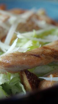 chicken caesar salad in a bowl 