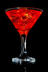 Cocktail juice glass isolated closeup shot on black background 