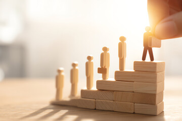 Wooden figurines with briefcases stand on ascending blocks, symbolizing career growth, promotion, and professional success in a bright, softly lit setting