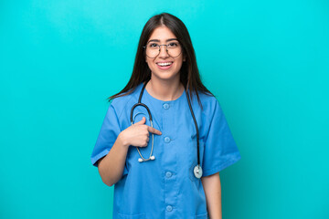 Young nurse caucasian woman isolated on blue background with surprise facial expression