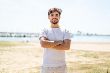 Handsome Arab man at outdoors keeping the arms crossed in frontal position