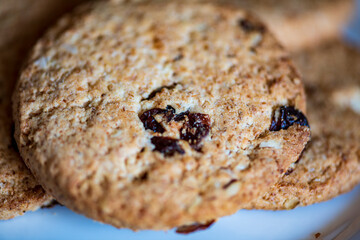 Healthy whole grain cookies with dried fruit on a white plate