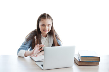 Smiling Caucasian girl learning online with laptop and chatting with people in classroom of school. Education cancept