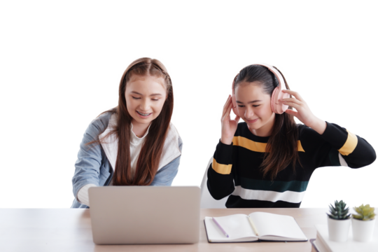 Smiling couple Caucasian girl listening to music with headphone and learning online with laptop together in classroom of school. Education cancept - Powered by Adobe
