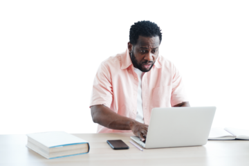 African American businessman surprised and working with laptop on desk
