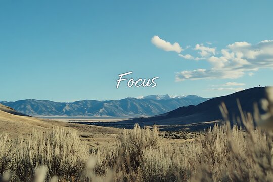 A peaceful mountain landscape displaying the word “focus” across the peaks.
