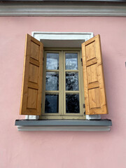 Window and shutters on the wall of the house