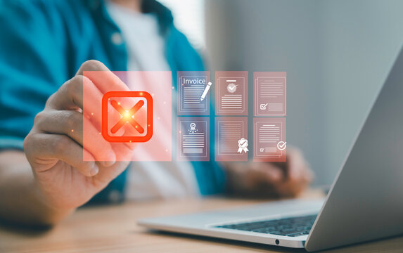 Businessman pressing cancel icon on virtual screen with invoice and document files for concept of rejection, error failed approval and financial document management.