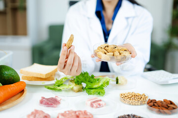 Nutrition expert in lab coat presenting soybeans and almonds in petri dishes. Healthy food, protein, diet, and food science concept. Clinical setting