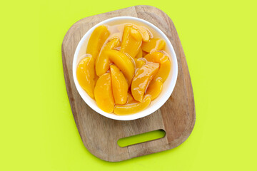 Sliced peaches in syrup served in a bowl