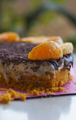 Chocolate cake with a slice of tangerine