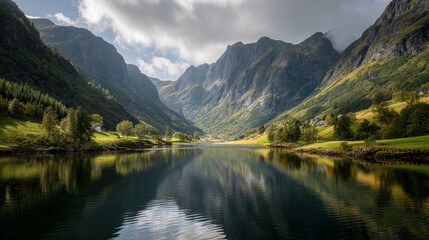 Fototapeta premium Calm lake reflects towering mountains under cloudy skies in a scenic landscape
