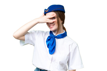 Airplane stewardess over isolated chroma key background covering eyes by hands and smiling