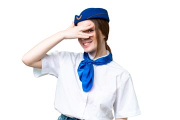 Airplane stewardess over isolated chroma key background covering eyes by hands and smiling