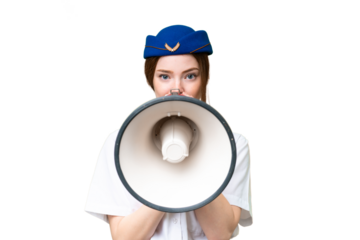 Airplane stewardess over isolated chroma key background shouting through a megaphone