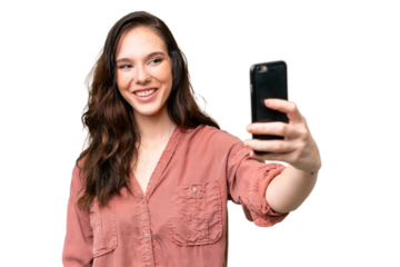 Young caucasian woman over isolated background making a selfie with mobile phone