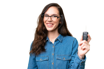 Young caucasian woman holding car keys over isolated background with happy expression