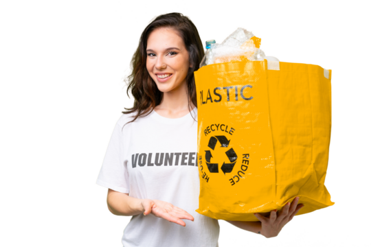 Young caucasian woman holding a bag full of plastic bottles to recycle over isolated background with happy expression