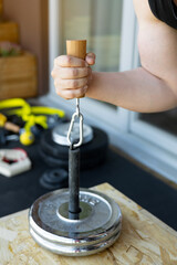 Close-up of a hand gripping a wooden handle during a sport-specific hammer curl for armwrestling training. Perfect for fitness, strength training, and armwrestling technique illustrations