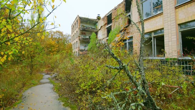 Footage captures the eerie and melancholic beauty of an abandoned school in Pripyat, Ukraine, within the Chernobyl Exclusion Zone. Overgrown with vegetation and bearing the marks of time and neglect, 
