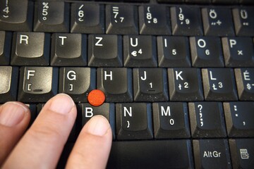 Close-up of human hand typing on a computer keyboard. Concept of digital work, business and communication.