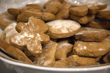 Close-up of traditional homemade gingerbread cookies served on a plate. Christmas festive concept with cozy holiday mood.